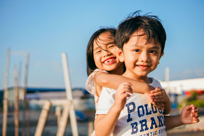 Portrait of smiling boy against sky