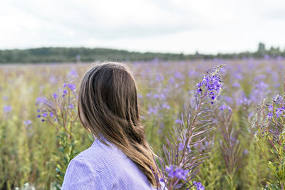 Portrait of woman standing on lavender field