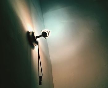 Low angle view of electric lamp against sky