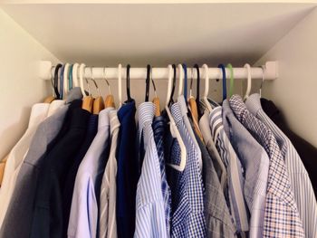 Close-up of shirts hanging in wardrobe