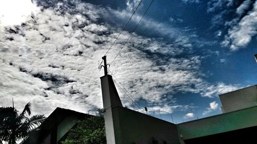 Low angle view of silhouette built structure against sky