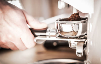 Close-up of hand holding coffee cup