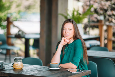 Portrait of woman sitting in restaurant