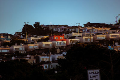 Buildings in city against clear sky