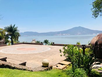 Scenic view of sea against clear blue sky