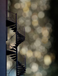 Low angle view of spiral staircase by building against sky
