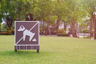 Close-up of sign on grass