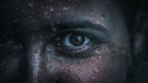 Close-up portrait of woman with wet face during monsoon