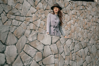 Portrait of woman on stone wall