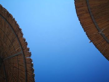 Low angle view from sunbed against clear blue sky