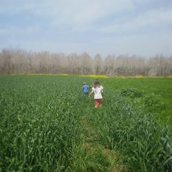 Man in farm against sky