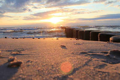 Scenic view of beach against sky during sunset