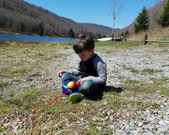 Boy playing with toy while sitting at lyman run state park