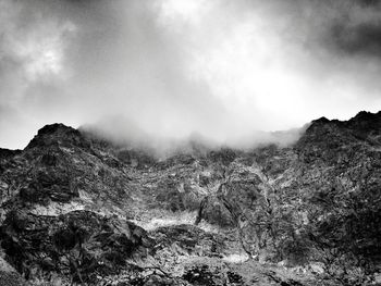 Scenic view of mountains against cloudy sky