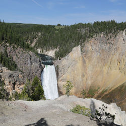 Scenic view of waterfall against sky