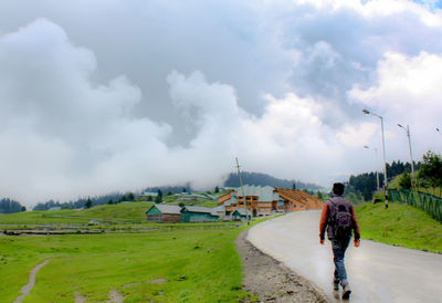 Traveller walking on the street in the village on the hill