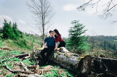 Loving girlfriend embracing boyfriend in forest