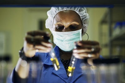 Close-up of scientist holding test tubes