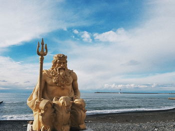 Statue of sea against cloudy sky