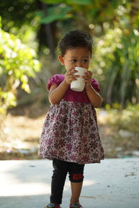 Full length of cute girl standing outdoors