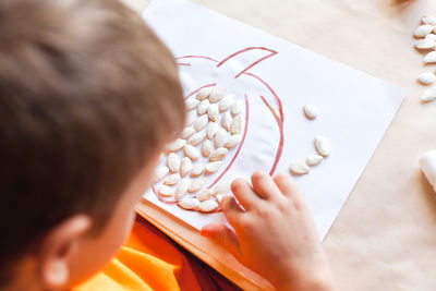 High angle view of boy holding table