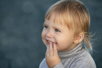 Close-up of cute boy looking away