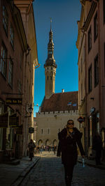 People in city against sky