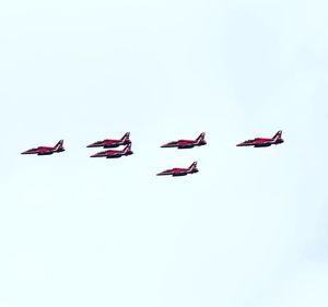 Low angle view of airshow against clear sky