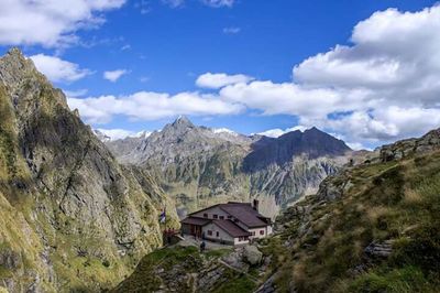 Scenic view of mountains against cloudy sky