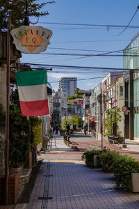 Street amidst buildings against sky