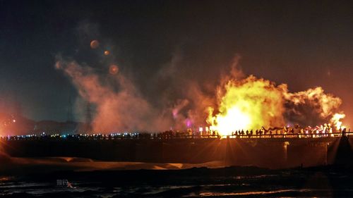 Panoramic view of illuminated city against sky at night