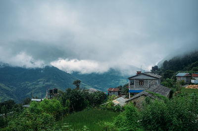 Panoramic view of village and buildings against sky