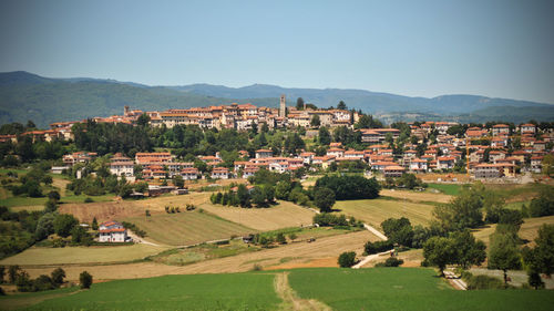 High angle view of houses in town against clear sky