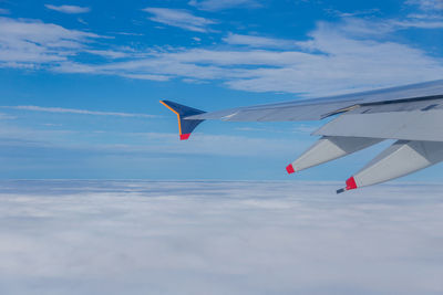 Airplane wing against sky