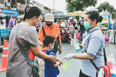 People standing on street market in city