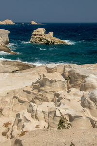 Rocks on beach against sky