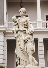 Low angle view of statue against sky in city