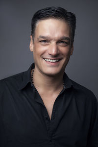 Portrait of young man against gray background