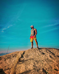 Full length of woman standing on rock