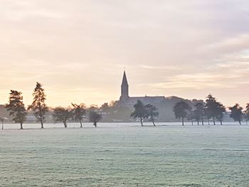Statues on landscape against sky