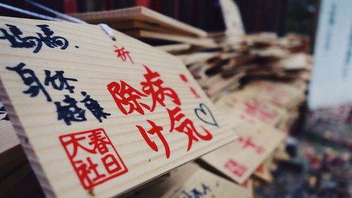 Close-up of wishing labels at temple