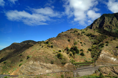 Low angle view of mountain against blue sky