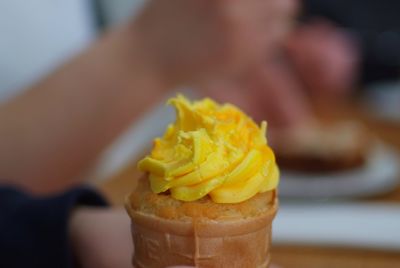 Close-up of hand holding ice cream