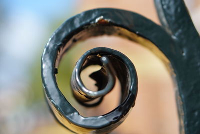 High angle view of spiral metal on railing