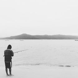 Silhouette of woman standing on beach