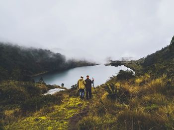 Man standing on mountain against sky