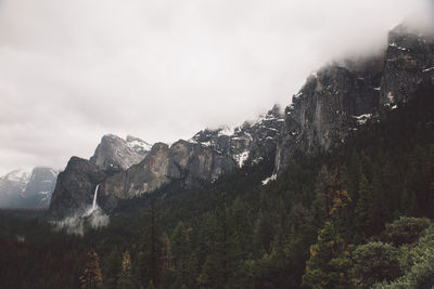 Scenic view of mountains against cloudy sky