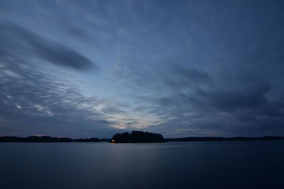 Scenic view of calm sea against cloudy sky