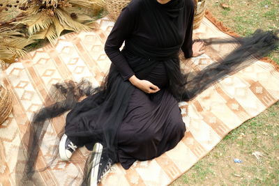 High angle view of woman sitting outdoors