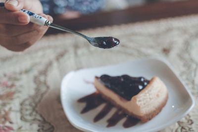 Close-up of person eating pie 